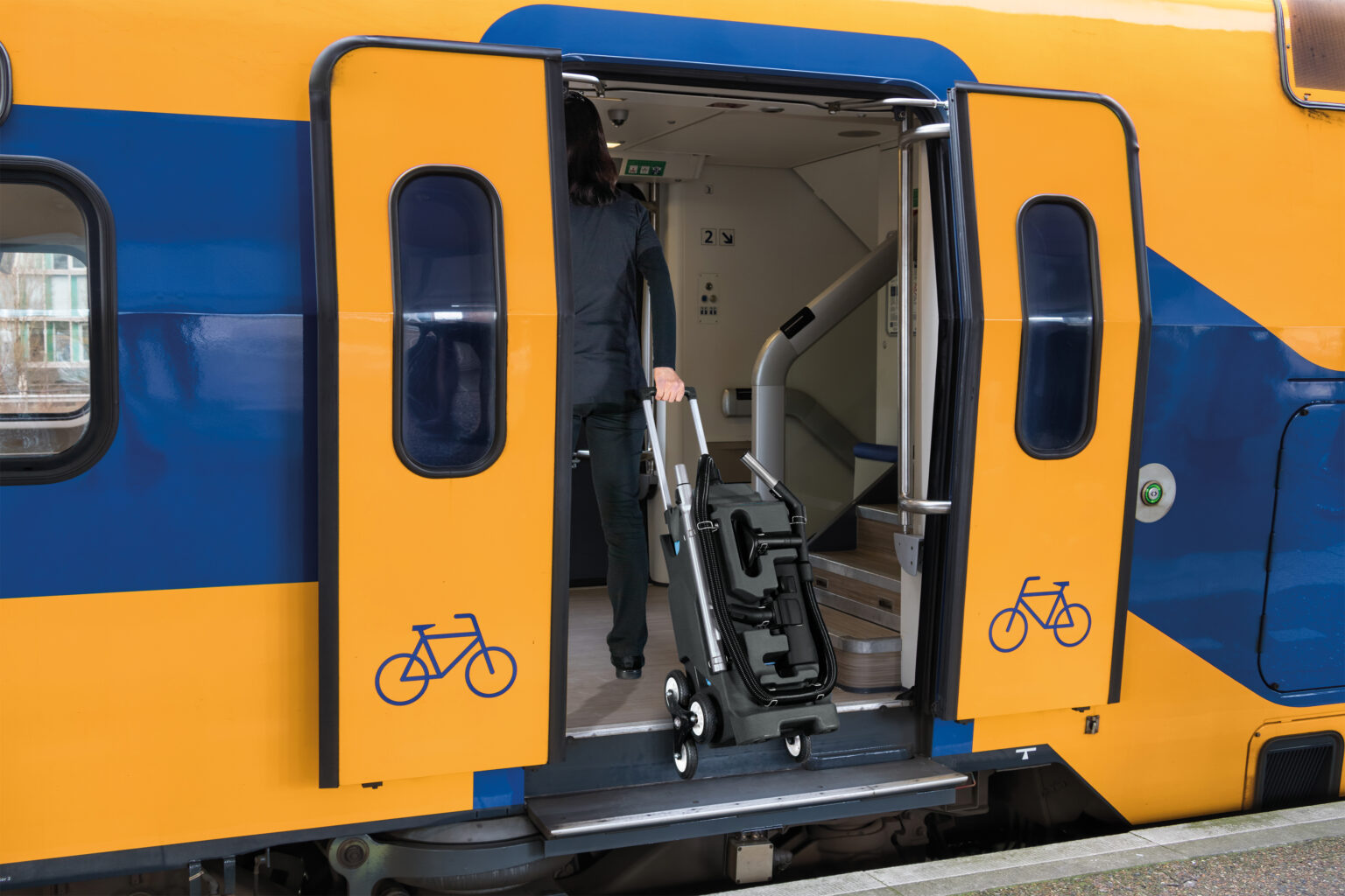 Train at Dutch railway platform with open doors