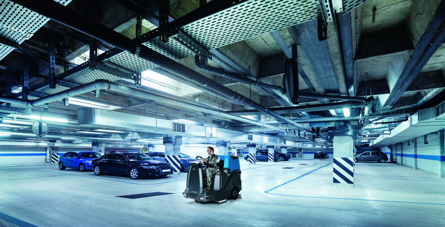 Parking garage, underground interior with a few parked cars